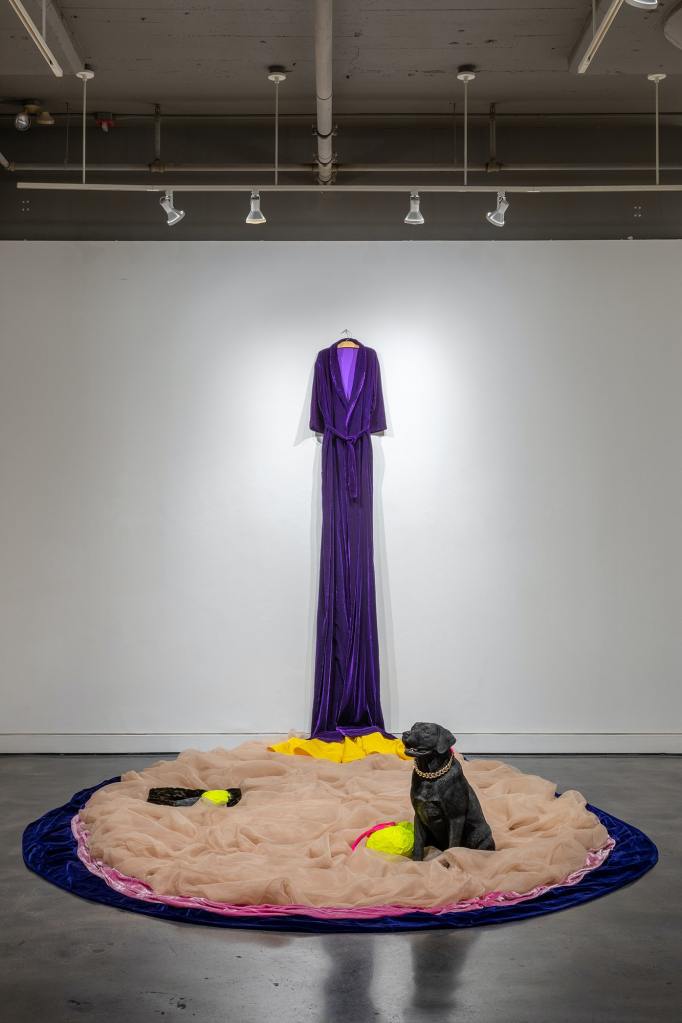 Beverly Semmes, Marigold, 2022. Velvet, organza, faux fur, silk, Alexander McQueen dress, stuffed and taped AMQ clutch purse and strap, taped AMQ shoes, painted plastic resin dog with AMQ clutch purse chain, 118 x 118 x 171 inches. Courtesy Locks Gallery, Philadelphia.