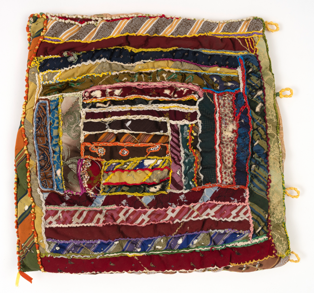 Elizabeth Talford Scott, “Untitled (Lap Cushion)” (circa early 1990s), fabric, beads, buttons, ribbon, thread, repurposed silk and fiber ties, 19 x 20 inches
